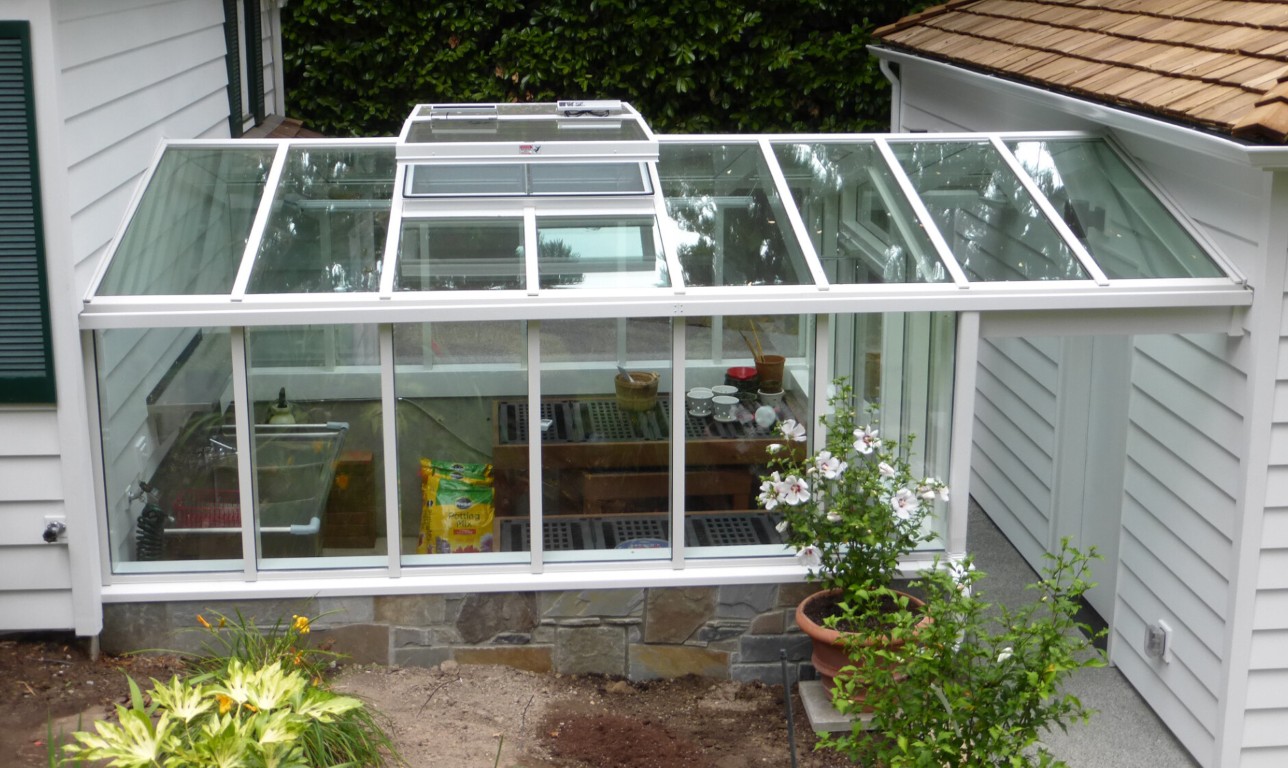 Greenhouse-style sunroom conversion with glass roof