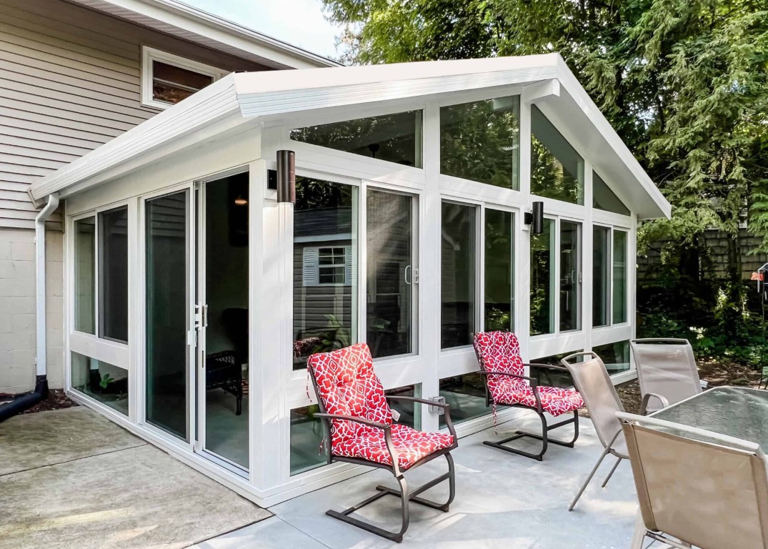 Modern patio enclosure with glass panels and white framing