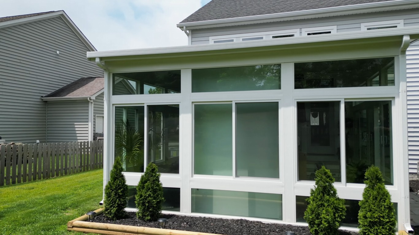 Screen room addition in residential backyard